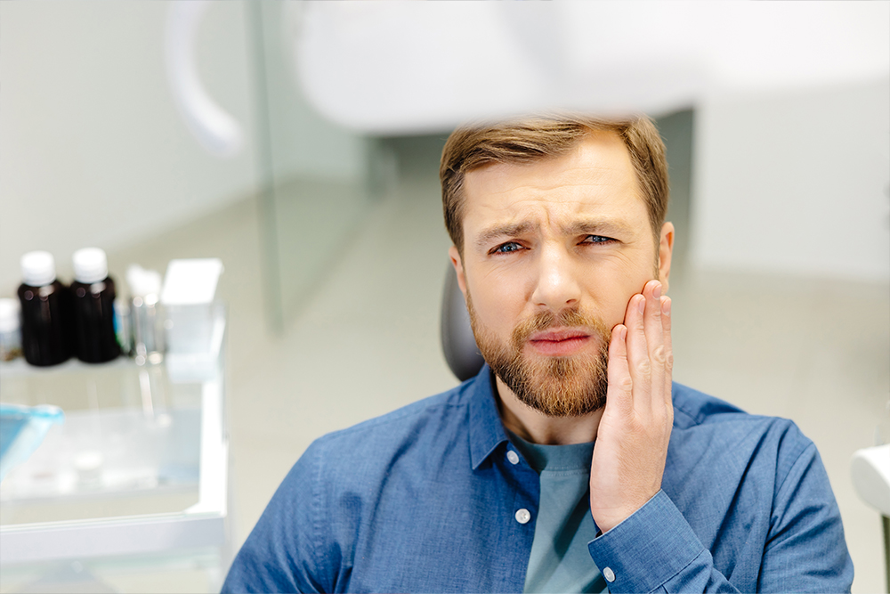 Dentist in North Whitby at Birch Dental providing emergency dental care to a patient experiencing tooth pain and swelling in a calm clinical setting