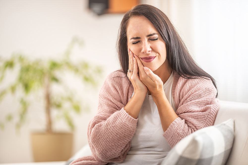 Dentist providing emergency dental care to a patient experiencing tooth pain in North Whitby.